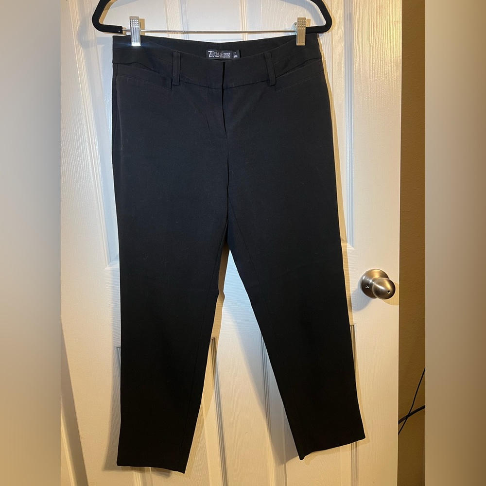 Black ankle pant with zipper detail. Excellent condition.